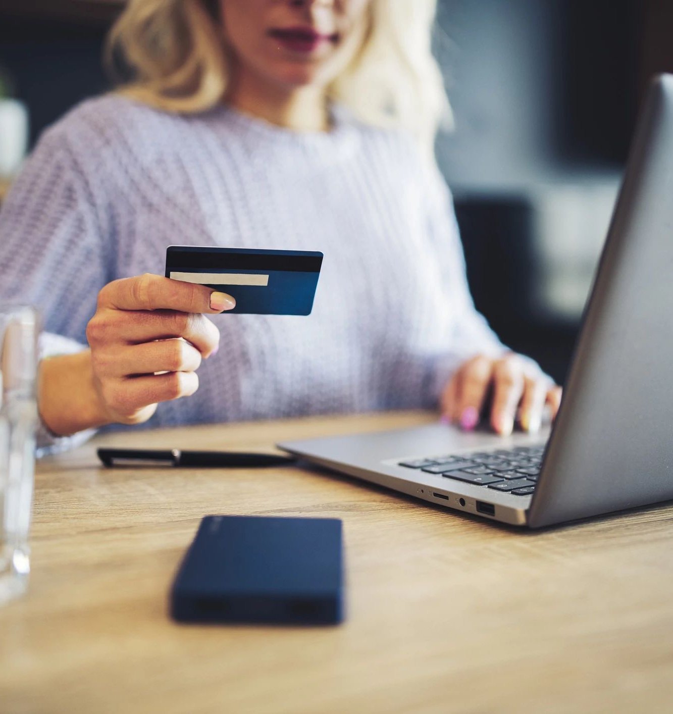 person using laptop to pay by card online at Wilmington Carpets in the Wilmington, OH area