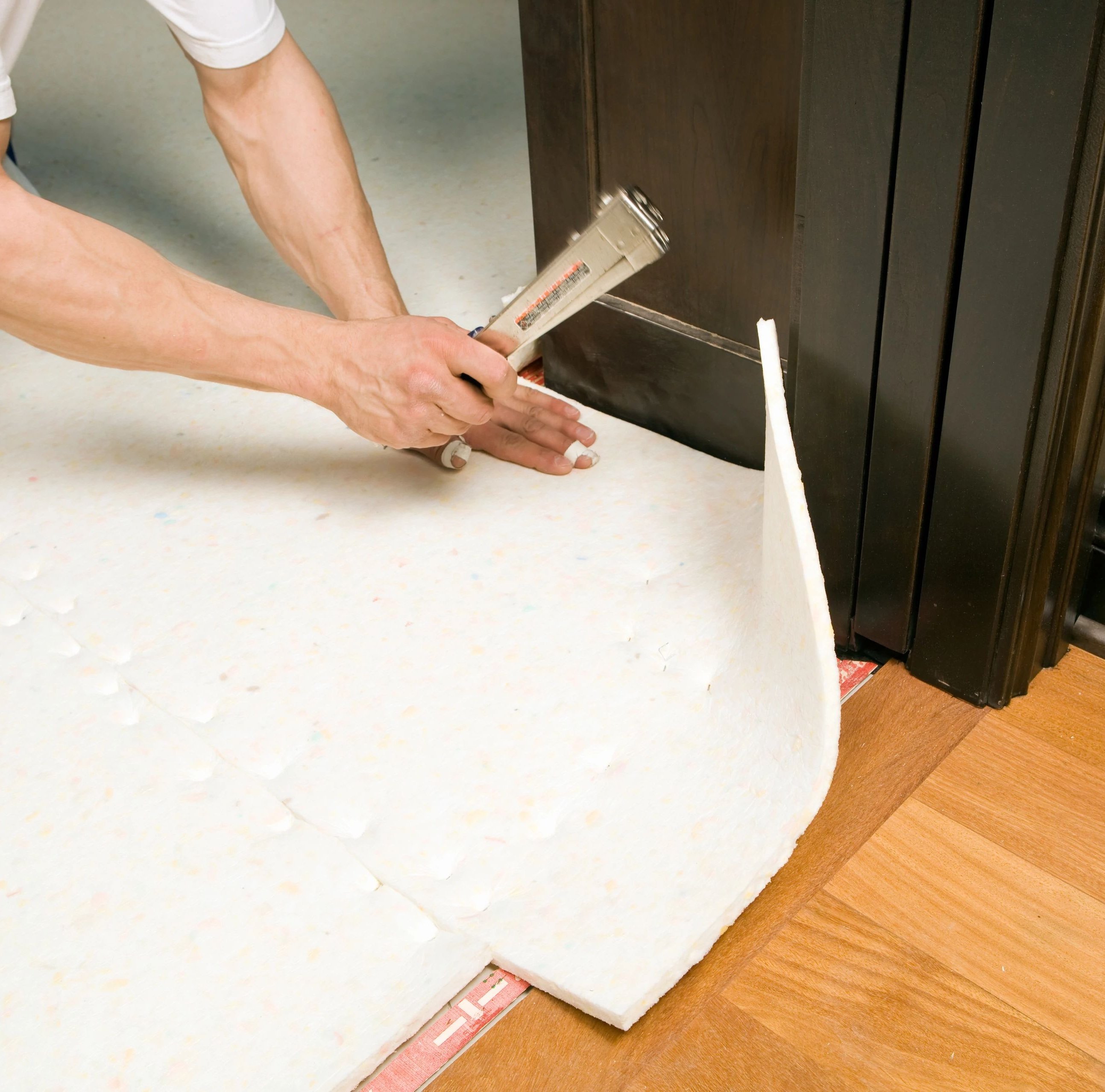person installing flooring underlayment from Wilmington Carpets in the Wilmington, OH area