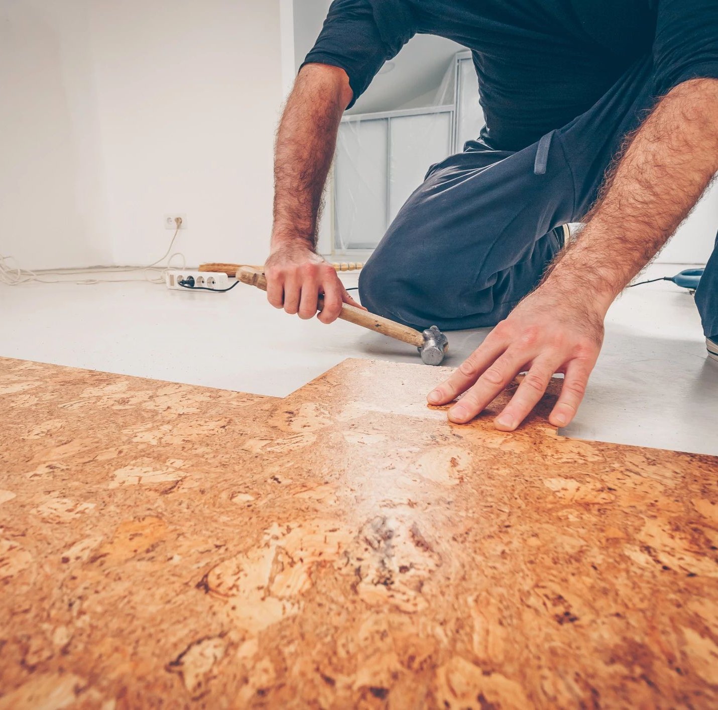person installing cork flooring from Wilmington Carpets in the Wilmington, OH area