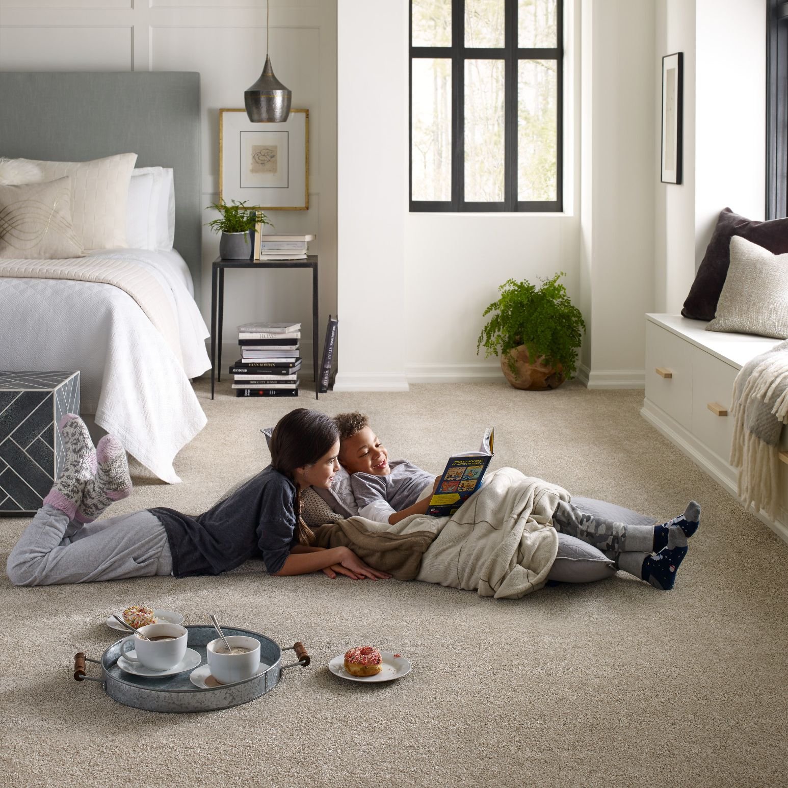 two kids reading on the floor on carpet - Wilmington Carpets Inc